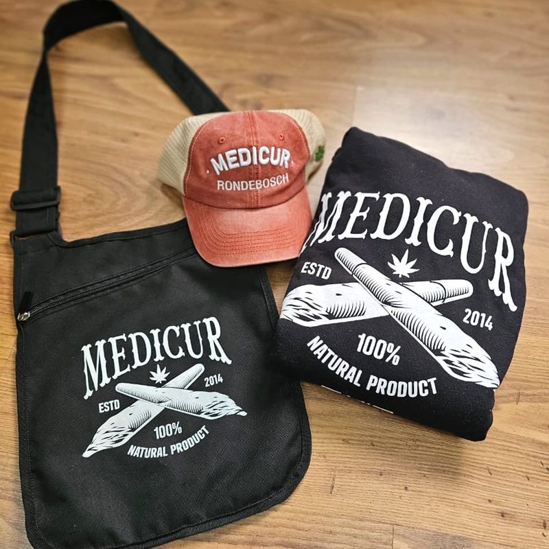 Black Medicur sling bag with a Medicur cap and hoodie